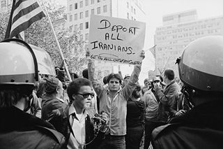 320px-Man_holding_sign_during_Iranian_hostage_crisis_protest,_1979-1.jpg